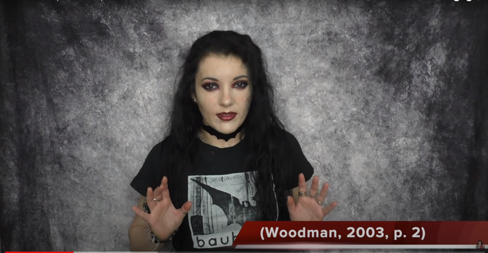 Angela Puca wearing a Bauhaus T-shirt presenting a video