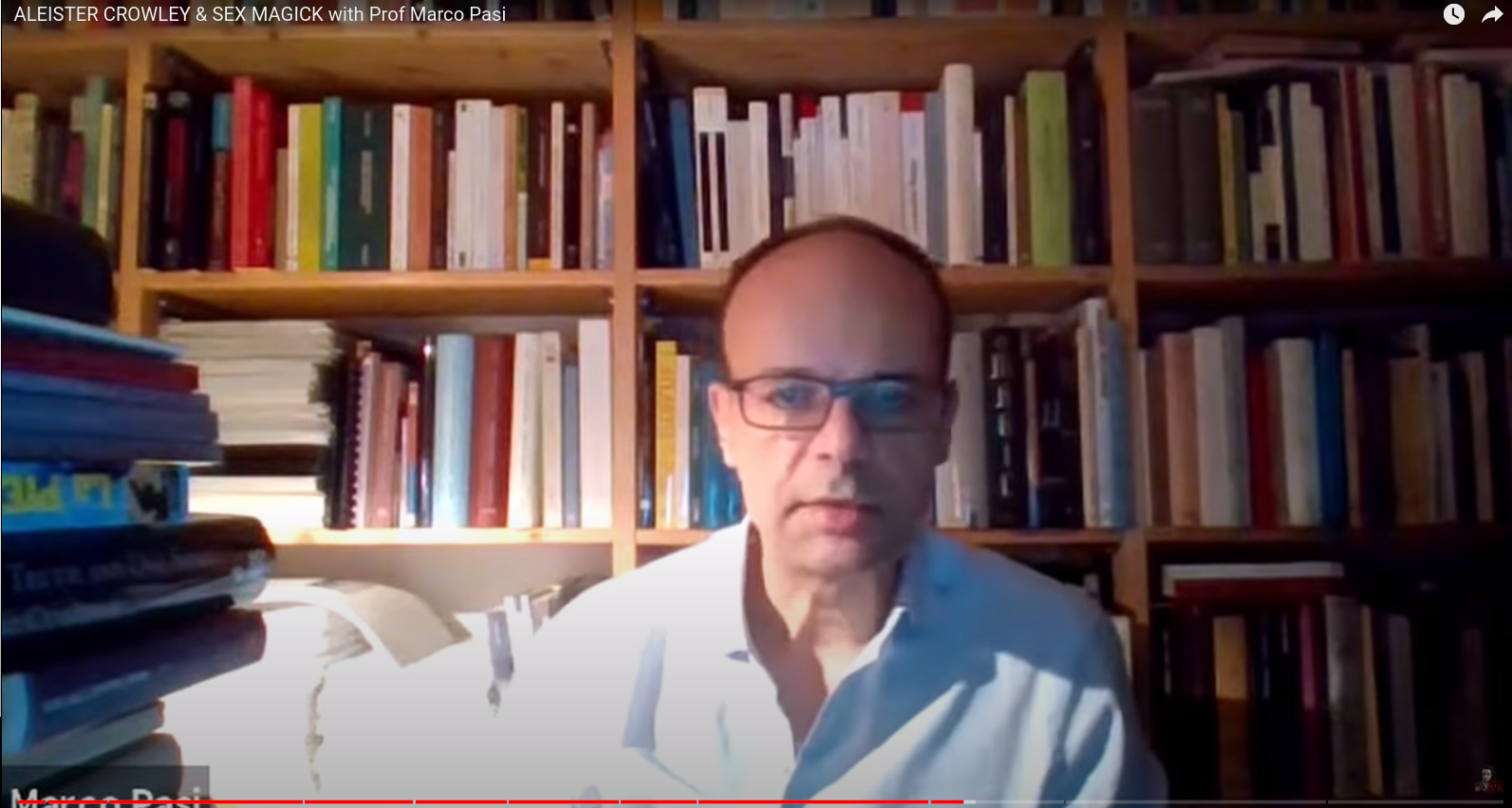 Prof Marco Parsi sitting before a wall of books